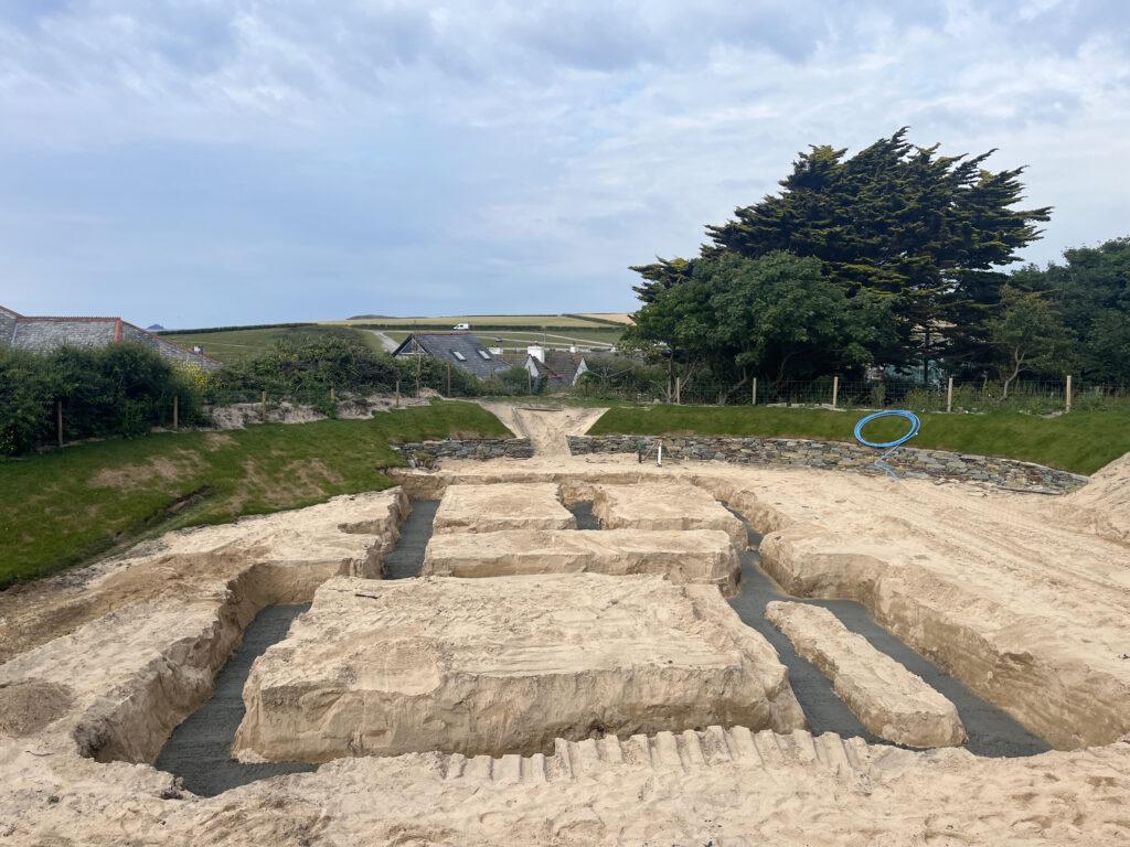 Trimming the ground for starting the new groundworks project in padstow
